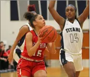  ?? RANDY MEYERS — FOR THE MORNING JOURNAL ?? Cora Sanders of Elyria drives by Imani Thomas of Lorain during the first quarter Feb. 17.