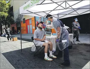  ?? Gary Coronado Los Angeles Times ?? NURSING STUDENT Luis Viafranco gives Michael Sun a COVID-19 test in San Francisco’s Mission District last month. State and county officials need accurate data to guide their response to the pandemic.