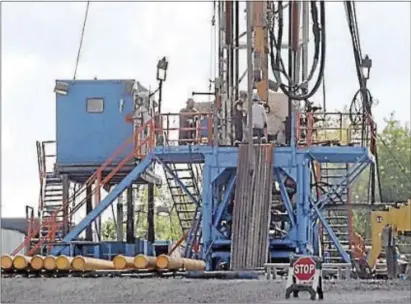  ?? ASSOCIATED PRESS ?? In this file photo, a crew works on a gas drilling rig at a well site for shale-based natural gas in Zelienople, Pa. The Pennsylvan­ia House is still debating a possible new severance tax on the industry.