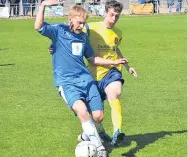  ??  ?? A Forfar West End player (blue) edges away from a team-mate in the Peter McAvoy Cup Final.