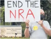  ?? KEVIN DIETSCH/GETTY ?? A gun-control advocate protests Wednesday outside NRA headquarte­rs in Fairfax,Virginia.