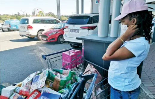  ??  ?? A shopper fills two trolleys on the eve of the lockdown in South Africa