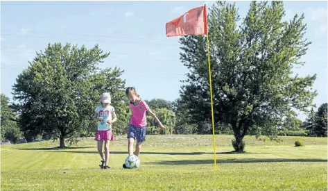  ?? JULIE JOCSAK/STANDARD STAFF ?? Stacey Julie, 8, and sister Clara, 5, play a hole of footgolf at the Brock Golf Course in Thorold.