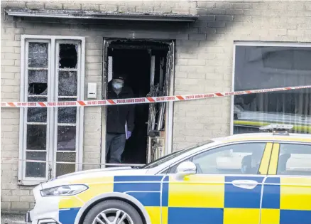  ??  ?? Gutted: Forensics officer at the scene of fire in Ballymoney