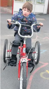  ??  ?? ●●Cerebral palsy and epilepsy sufferer George Rawcliffe riding his new specialist trike