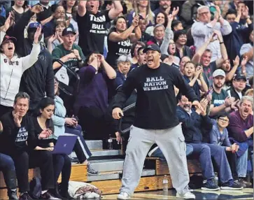 ?? Photog r aphs by Luis Sinco Los Angeles Times ?? THE CROWD GOES WILD as Chino Hills improves to 32- 0 with a victory over Reedley Immanuel on Friday night, and right in the center of it is LaVar Ball, father of the three stars of the team.