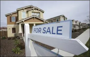  ?? ASSOCIATED PRESS ?? A “for sale” sign is posted in front of a home, March 3, in Sacramento, Calif.