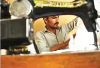  ?? AP ?? A tailor checks measuremen­ts before beginning his work at Needles Tailoring in Mardan. —