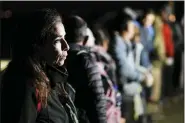  ?? ASSOCIATED PRESS FILE PHOTO ?? A woman from Cuba waits with other migrants to be processed to seek asylum after crossing the border into the United States, Jan. 6, near Yuma, Ariz.