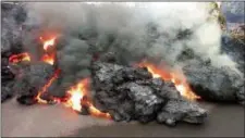  ?? SCOTT WIGGERS — APAU HAWAII TOURS VIA AP ?? In this photo from video a lava flow advancing down a road is seen from less than 10 feet away in the Leilani Estates subdivisio­n near Pahoa on the island of Hawaii Monday.