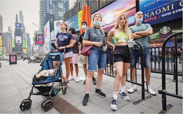  ?? Reuters ?? ↑
People watch the launch of Jeff Bezos and his three crew-mates on Blue Origin’s inaugural flight to the edge of space, on a screen in Times Square in New York City.