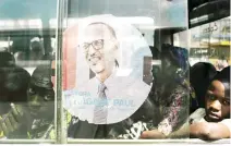  ??  ?? A bus adorned with an image of incumbent Rwandan President Paul Kagame at the central bus station in Kigali, in this July 30 photo. (AFP)