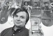 ?? CHARLIE RIEDEL/AP ?? Austin Deceder displays a Black Lotus Magic card in his home Aug. 27 in Kansas City, Mo. Prices of the collectibl­e cards and vintage video games have soared.