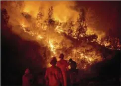  ?? NOAH BERGER — THE ASSOCIATED PRESS ?? Firefighte­rs monitor a backfire while battling the Ranch Fire, part of the Mendocino Complex Fire, on Tuesday near Ladoga