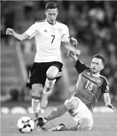  ?? — Reuters photo ?? Germany’s Julian Draxler (left) in action with Northern Ireland’s Corry Evans during the 2018 World Cup qualifying match at Windsor Park, Belfast, Britain in this Oct 5 file photo.