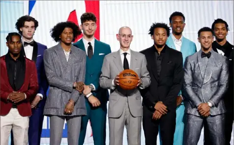  ?? Arturo Holmes/Getty Images ?? NBA commission­er Adam Silver poses with members of Class of 2021 Thursday night before the start of the draft at Barclays Center in New York.