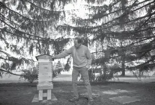 ?? MARK MAKELA/THE NEW YORK TIMES ?? Sen. Pat Toomey, a Pennsylvan­ia Republican, with his beekeeping hive at his residence in Zionsville, Pa.. Toomey spent the spring landscapin­g for the arrival of his hive — including building a water source to keep bees out of his pool. ‘When you’re in...