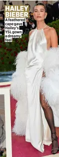  ?? ?? A feathered cape gave Hailey’s YSL gown a dreamy feel HAILEY BIEBER