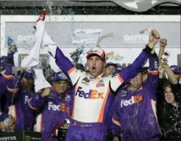  ?? JOHN RAOUX — THE ASSOCIATED PRESS ?? Denny Hamlin celebrates in Victory Lane Sunday after winning the Daytona 500 for the second time in four years.