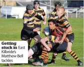  ??  ?? Getting stuck in East Kilbride’s Matthew Bell tackles