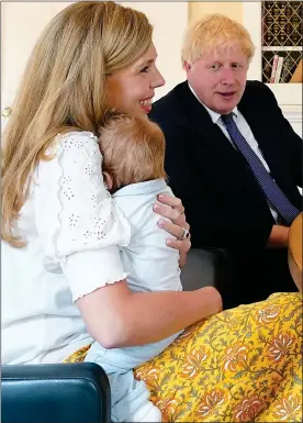  ??  ?? THAT’S OUR BOY: Boris, Carrie and Wilfred inside Downing Street last year