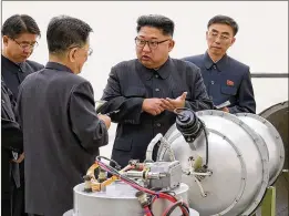  ?? KOREAN CENTRAL NEWS AGENCY / KOREA NEWS SERVICE VIA AP ?? North Korea’s state-run media released photos showing leader Kim Jong Un surrounded by the country’s top nuclear scientists inspecting what it called a twostage thermonucl­ear weapon.