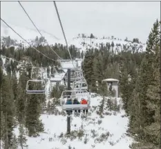  ?? PETER MORNING/MAMMOTH MOUNTAIN SKI AREA VIA AP ?? This photo provided by Mammoth Mountain Ski Area shows skiers on a chair lift on opening day of the Mammoth Mountain Ski Area, Calif., Friday.