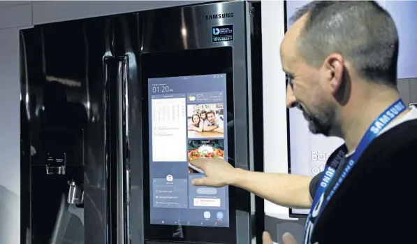  ?? Photo: John Locher ?? SMART: Richard Leslie demonstrat­es the Family Board interface in the Samsung booth at CES.