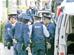  ?? — AFP photo ?? Policemen prepare for inspection in front of an apartment in Zama,Kanagawa,where police found nine dismembere­d corpses.