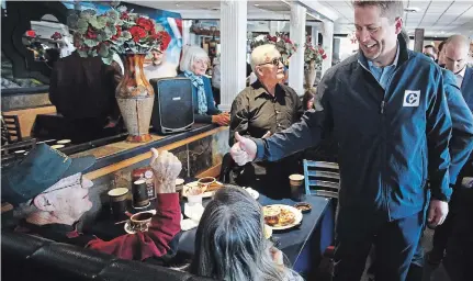  ?? CLIFFORD SKARSTEDT EXAMINER ?? Conservati­ve Leader Andrew Scheer greets supporters during a campaign stop at the Pizza Factory restaurant on Lansdowne Street on Saturday.