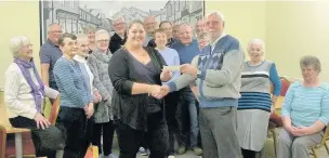  ??  ?? ●●Emma Carr collects £1,000 from Bredbury and Romiley Community Assocation,