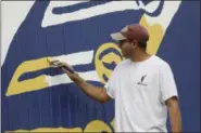  ?? ANDY MORRISON — THE BLADE VIA AP ?? Scott Hagan, known as the barn painter, paints an image of Commodore Oliver Hazard Perry on the side of a barn in Oak Harbor, Ohio.