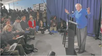  ?? PABLO MARTINEZ MONSIVAIS/AP ?? Sen. Bernie Sanders speaks Thursday at his New Hampshire headquarte­rs in Manchester. The Sun-Times’ Lynn Sweet is seated at left.