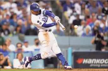  ?? Marcio Jose Sanchez / Associated Press ?? The Los Angeles Dodgers Mookie Betts singles on a line drive to shortstop during the third inning of a National League Wild Card playoff game against the St. Louis Cardinals on Wednesday in Los Angeles.