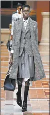  ?? GETTY ?? Thom Browne’s frayed-edge jacket and matching coat.