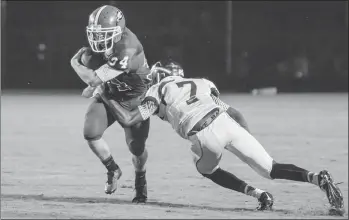  ?? Ryan Gibson / NPCo ?? Model’s Tyler Dean (7) tries to bring down Sonoravill­e’s Brandon Dendy during Friday night’s game.