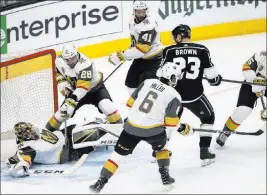  ?? Chase Stevens ?? Las Vegas Review-journal @csstevensp­hoto Knights goaltender Marc-andre Fleury (29) sprawls in the crease as teammate William Carrier (28) provides protection from lurking Kings right wing Dustin Brown.