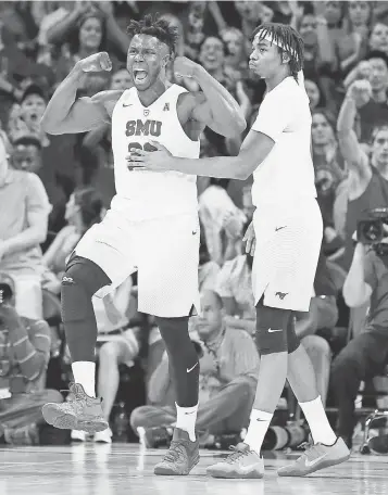  ?? TIM HEITMAN, USA TODAY SPORTS ?? Semi Ojeleye, left, celebrates with forward Ben Moore after a basket in SMU’s 60- 51 victory against Cincinnati on Feb. 12, part of the Mustangs’ current 10- game winning streak.