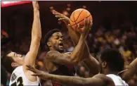  ?? AP/L.G. PATTERSON ?? Arkansas’ Daryl Macon (center) shoots between Missouri’s Cullen VanLeer (left) and Jeremiah Tilmon during the first half Saturday in Columbia, Mo. The Razorbacks, who lost 77-67, open SEC Tournament play in St. Louis on Thursday night against either...