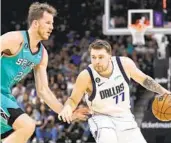  ?? DARREN ABATE AP ?? Mavericks’ Luka Doncic, who scored 51 points, drives against Spurs’ Jakob Poeltl during the first half.