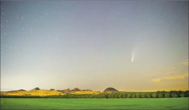  ?? Chris Kaufman/ Appeal-democrat ?? Comet NEOWISE is seen in the sky above the Sutter Buttes from East Butte Road on Tuesday in Sutter County.