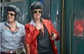  ?? — AFP ?? Train conductors dressed as Elvis Presley wait for the train to leave Central station to take people to the Parkes Elvis Festival, in Sydney on Thursday.