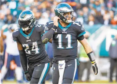  ?? CHRIS SZAGOLA/AP ?? Eagles quarterbac­k Carson Wentz (11) looks back as he and running back Jordan Howard (24) head off the field on Nov. 3.