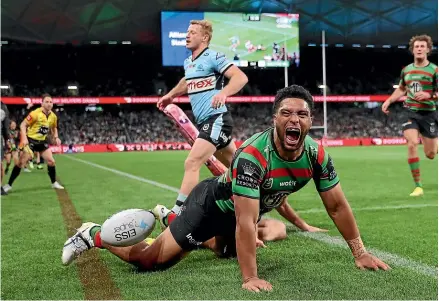  ?? GETTY IMAGES ?? Taane Milne celebrates a try in the Rabbitohs’ NRL semifinal win over the Sharks on Saturday night.