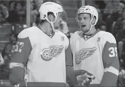  ?? The Canadian Press ?? Detroit Red Wings forward Anthony Mantha and defenseman Jonathan Ericsson talk strategy against the Florida Panthers in a recent game.