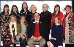  ?? (NWA Democrat-Gazette file photo/Jocelyn Murphy) ?? Alison Levin (seated, from left), Eva Terry, Tyler Clark, Ashley Wardlow, Elizabeth Prenger (standing, from left), Cindy Long, Emily Rappe Fisher, Megan Cuddy, Jaclyn Keeter, Sarah Du Preez and Allison McElroy, 2018-19 AFP Northwest Arkansas board members, welcome guests to a previous National Philanthro­py Day luncheon.