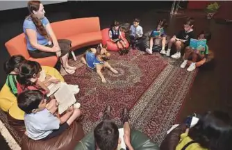  ?? Clint Egbert/Gulf News ?? Children read stories aloud to their furry friend during a Reading Dogs session at Gems Modern Academy in Dubai on Wednesday.