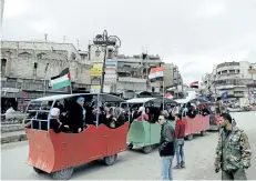  ?? JOSEPH EID/GETTY IMAGES ?? People ride in a makeshift trolley down a street in Hama, central Syria, on Monday. The UN says a school was purposeful­ly bombed by government forces in October, killing 21 children.