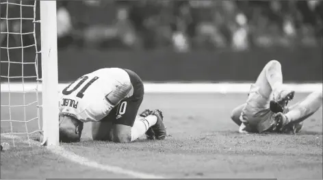  ?? EDUARDO VERDUGO/AP ?? UNITED STATES’ CHRISTIAN PULISIC (left) and Mexico’s goalkeeper Guillermo Ochoa grimace on the ground following a clash during a qualifying soccer match for the FIFA World Cup Qatar 2022 at Azteca stadium in Mexico City on Thursday.