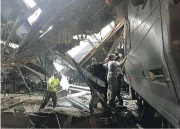  ?? PANCHO BERNASCONI / GETTY IMAGES ?? Train personnel survey the NJ Transit train that crashed into the platform at the Hoboken Terminal on Thursday. The train ran off the end of its track as it approached the station, smashing through a concrete-and-steel bumper.